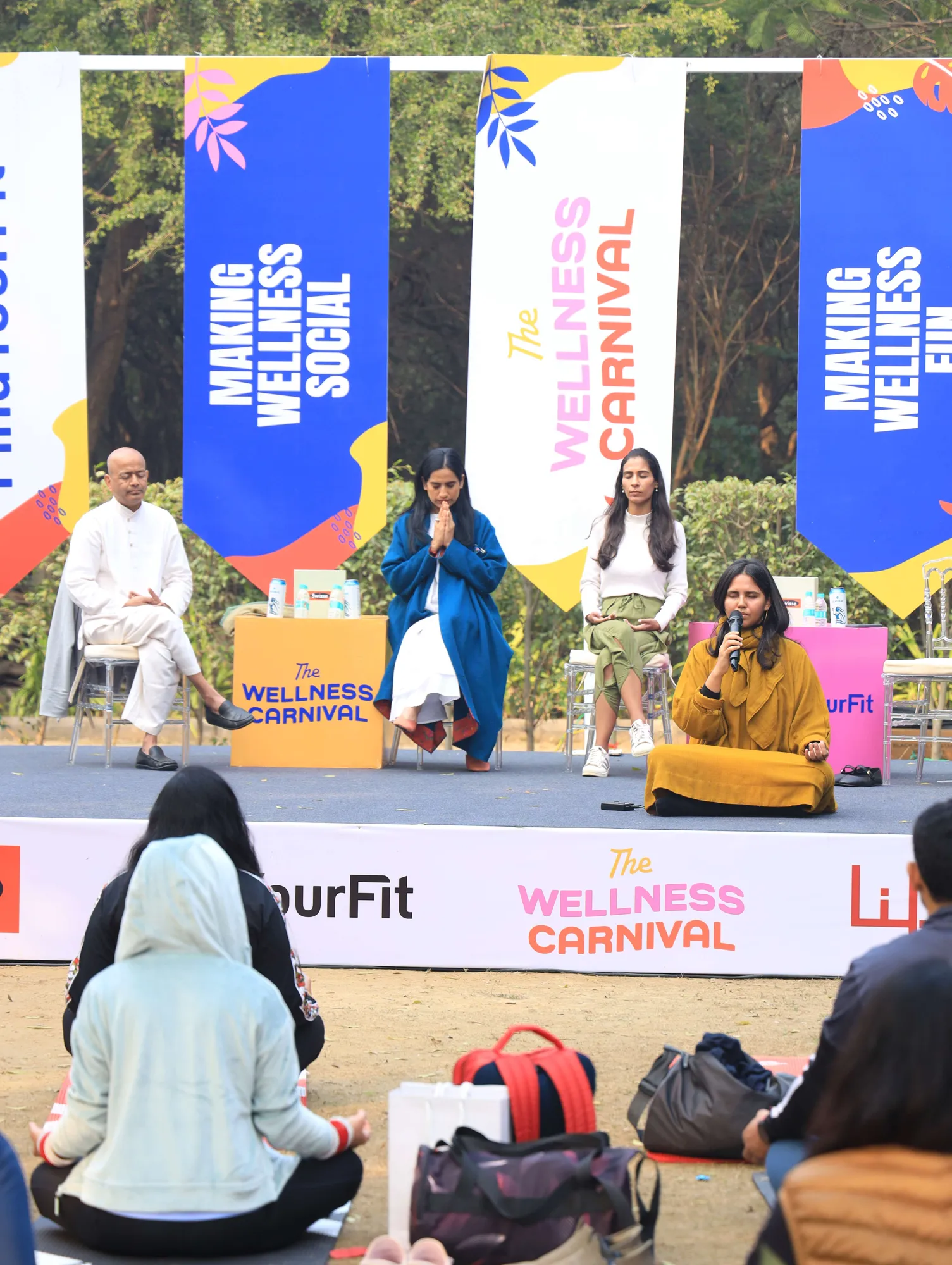 Participants mid-session on the main stage ground at a Wellness Carnival
